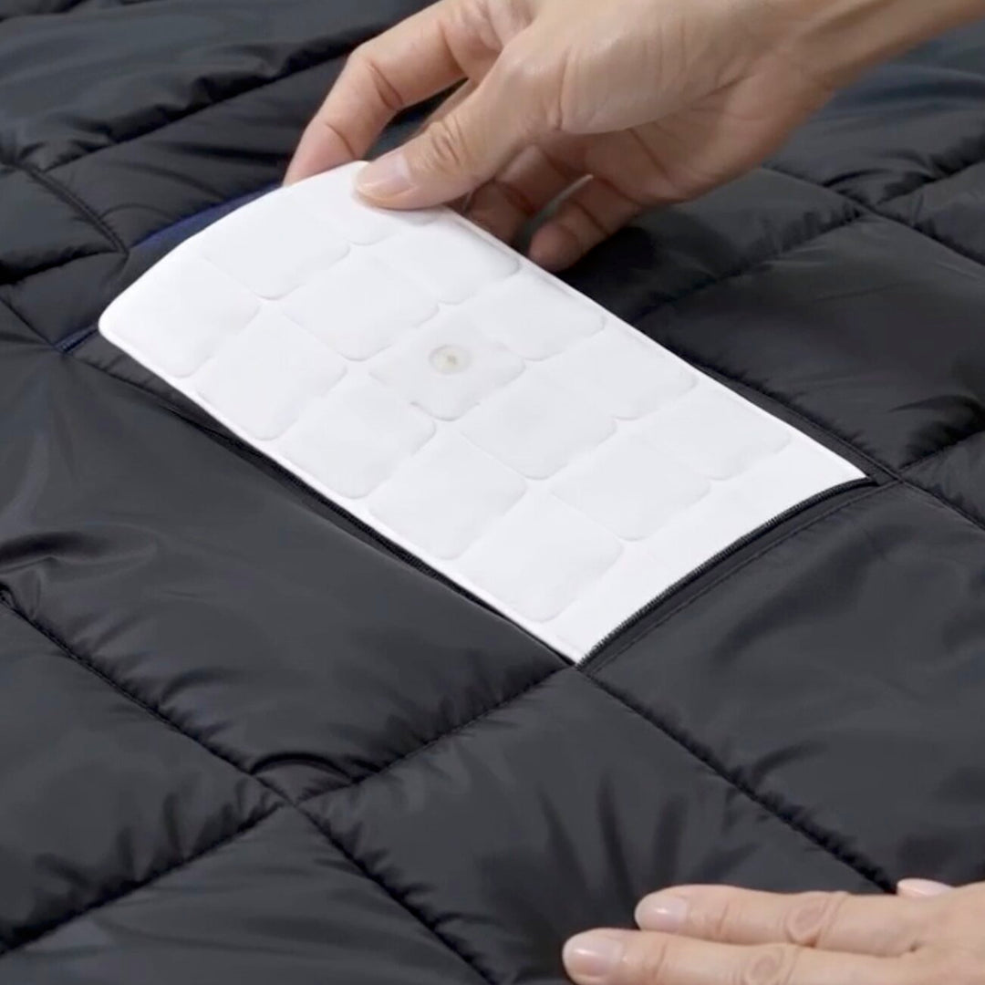 A TGPad being seated in a ThermoGen vest pocket